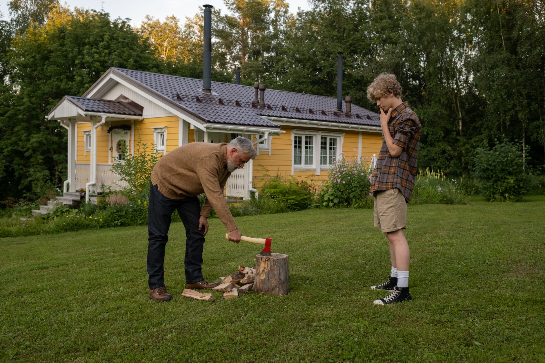 A portable inverter generator running on a driveway outside a garage