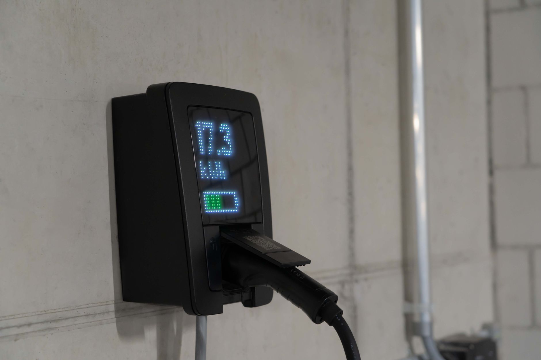 wall-mounted home battery unit installed in a residential garage