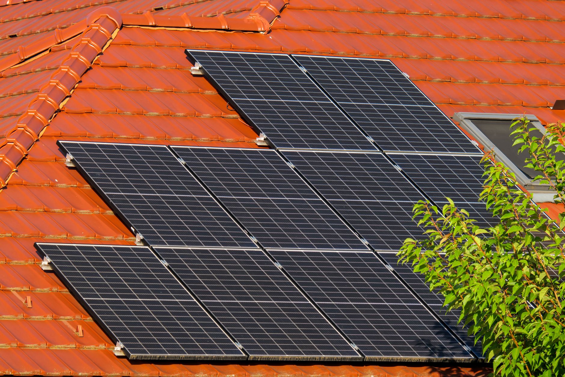 Residential solar panels and a utility meter on the side of a house