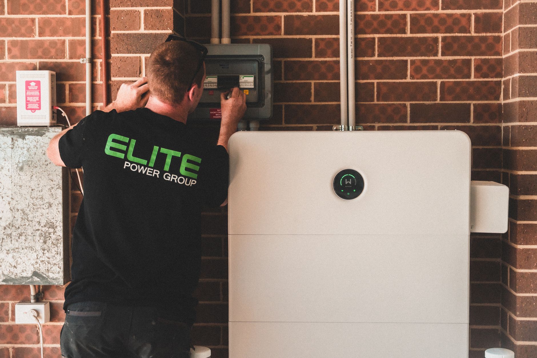 A home battery backup system mounted on a garage wall